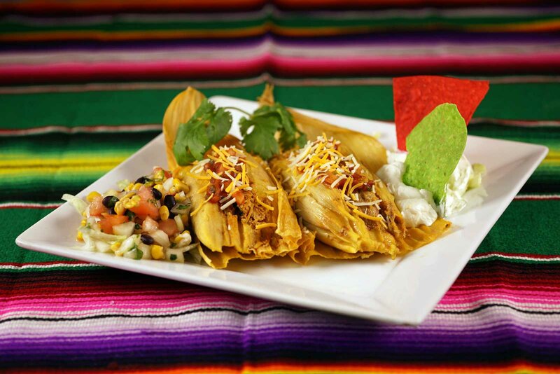 Tamale appetizer with tortilla chips, salsa and sour cream